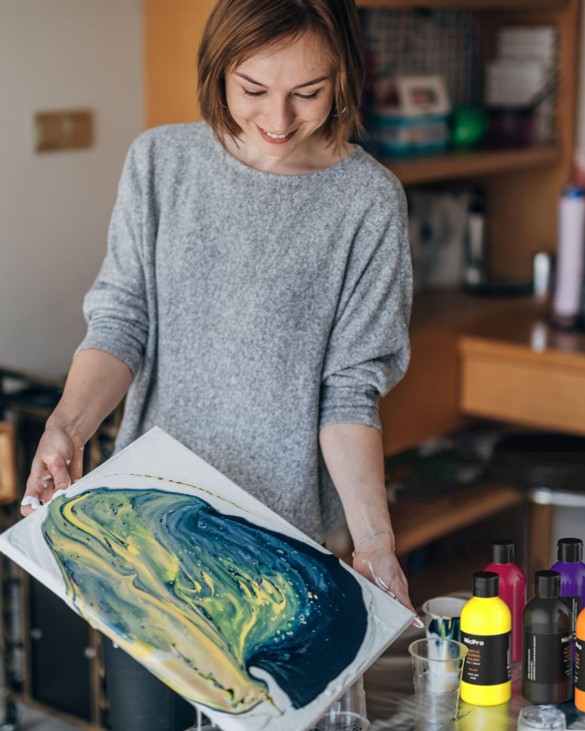 Female Artist Pouring Acrylic Medium Painting Stock Photo